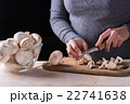 female hands cutting fresh mushrooms  22741638