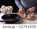 female hands cutting fresh mushrooms  22741639