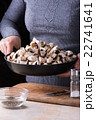 female hands hold fresh mushrooms in the pan 22741641