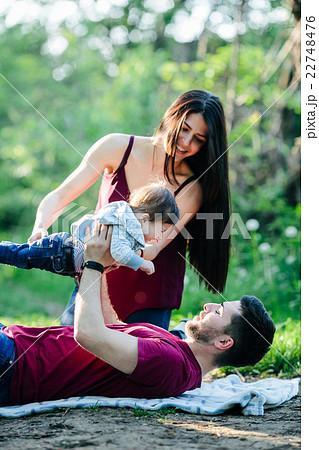 young family with a child on the nature young family with a child on the nature 22748476