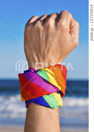 man with a rainbow-patterned kerchief in his wrist 22754814