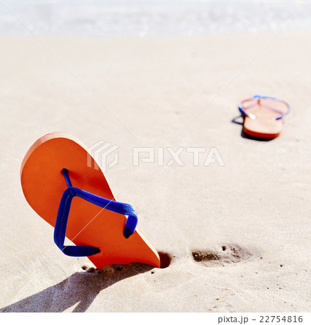 flip-flops on the sand of a beach 22754816