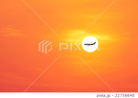 airplane on the beautiful sun and red sky. 22756640