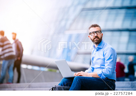 Manager with laptop, sitting on stairs, London Manager with laptop, sitting on stairs, London 22757284