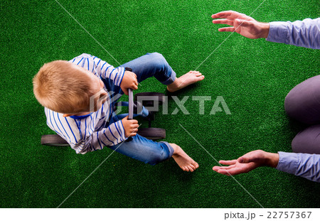 Unrecognizable father catching his son riding a 22757367