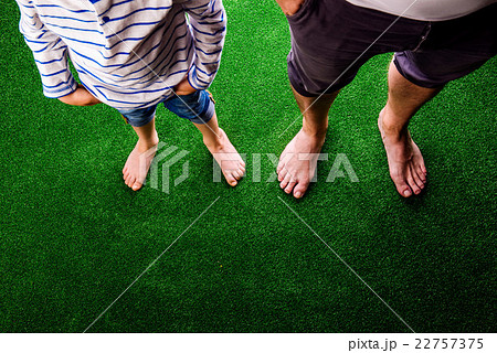 Unrecognizable father and son standing, against 22757375