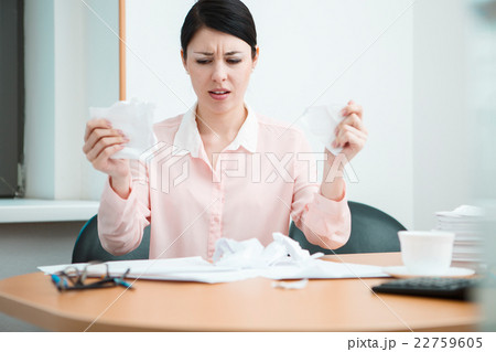 Woman in office with crumpled paper. 22759605