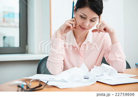 Businesswoman sitting at desk in the office in 22759606