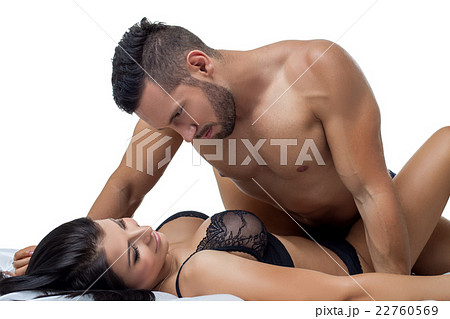 Portrait of bearded man and busty brunette in bed 22760569