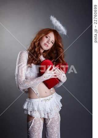 Innocent redhead girl dressed in angel costume Innocent redhead girl dressed in angel costume 22760699