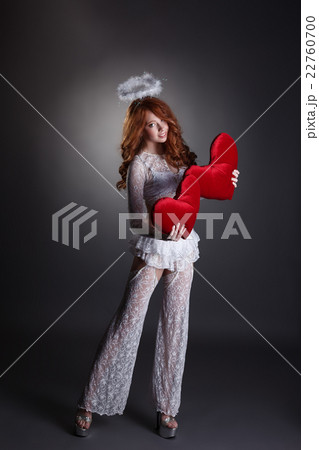 Lovely girl in angel costume posing with hearts Lovely girl in angel costume posing with hearts 22760700