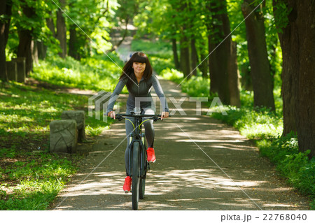 cyclist woman riding a bicycle in park 22768040
