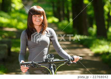 cyclist woman riding a bicycle in park 22768042