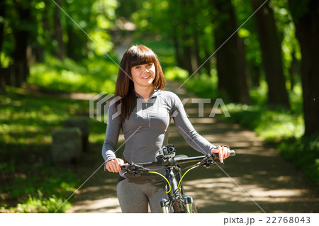 cyclist woman riding a bicycle in park 22768043