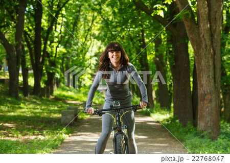 cyclist woman riding a bicycle in park 22768047
