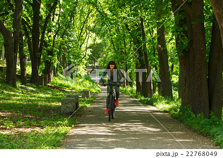 cyclist woman riding a bicycle in park 22768049