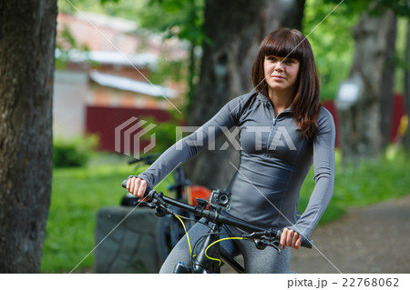 cyclist woman riding a bicycle in park cyclist woman riding a bicycle in park 22768062