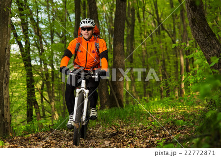 Cyclist Riding the Bike on a Trail in Summer Cyclist Riding the Bike on a Trail in Summer 22772871