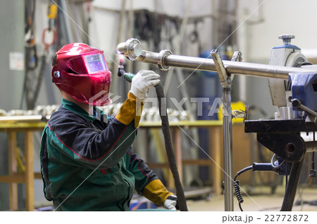 Industrial worker welding in metal factory. 22772872