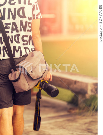 Close up of man holding a camera Close up of man holding a camera 22777689
