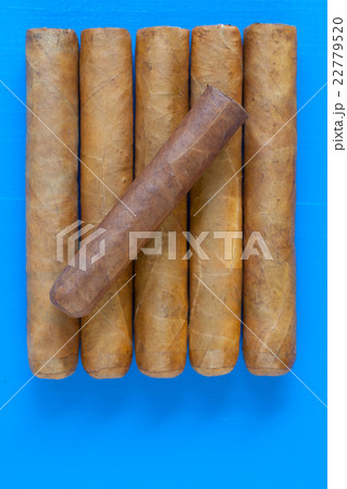 Detail of luxury Cuban cigars on the blue desk 22779520