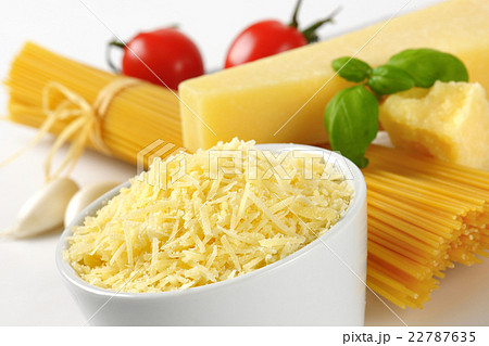 parmesan cheese and uncooked spaghetti parmesan cheese and uncooked spaghetti 22787635