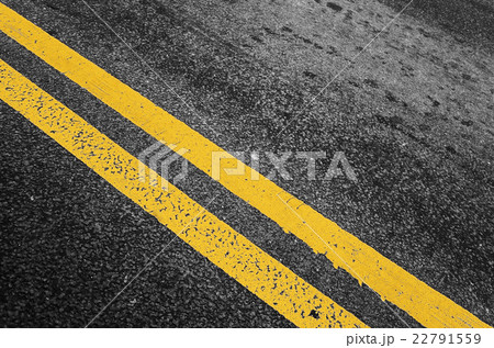 Yellow double dividing line over black highway 22791559