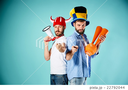 The two football fans with mouthpiece over blue 22792044
