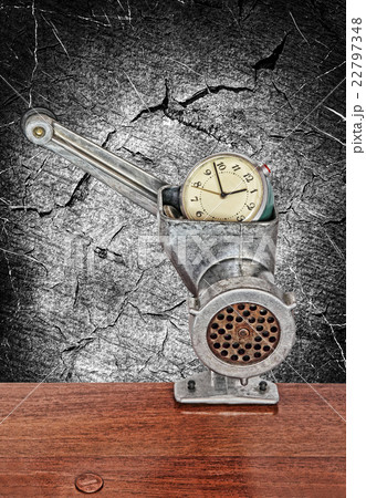 Alarm clock in meat grinder on grunge background 22797348