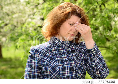 woman with headache on  spring nature  22798608