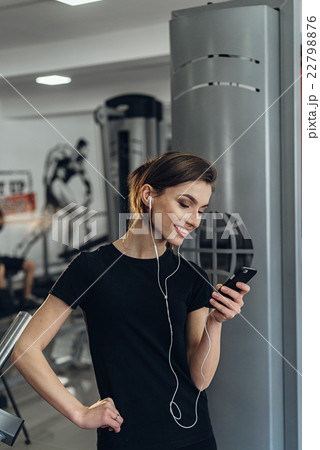 Beautiful girl in the gym with your phone Beautiful girl in the gym with your phone 22798876