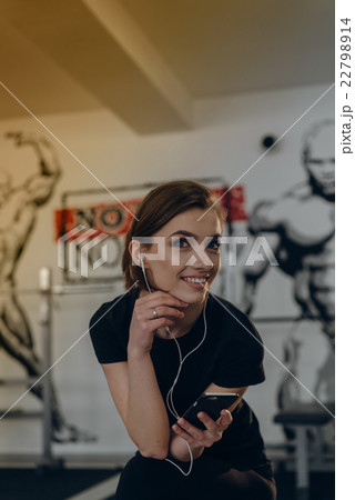 Beautiful girl at the gym listening to music Beautiful girl at the gym listening to music 22798914