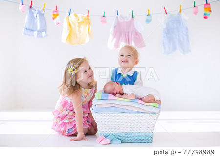 Brother and sister kissing newborn baby 22798989