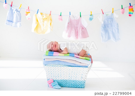 Newborn baby in a basket with towels 22799004