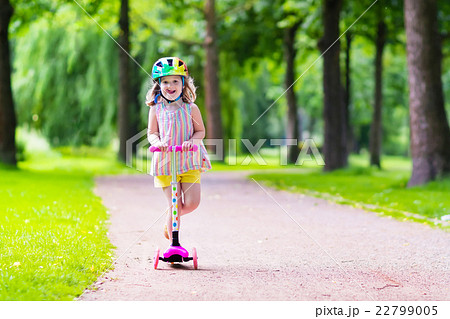 Little girl riding a colorful scooter 22799005