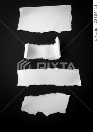 Torn paper on black background . Torn paper on black background . 22804411