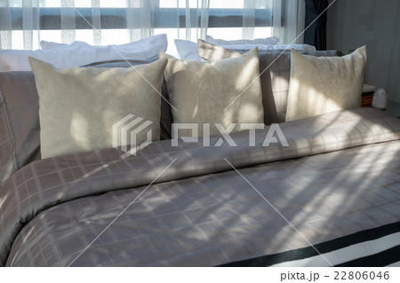 modern bedroom with brown pillows 22806046