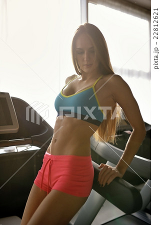 Sporty girl posing in gym Sporty girl posing in gym 22812621