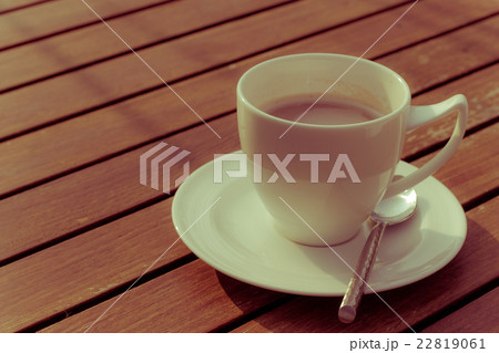 hot coffee and sunshine on wooden background hot coffee and sunshine on wooden background 22819061