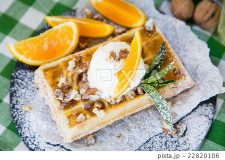 Belgian waffle with honey sauce, oranges, walnuts 22820106