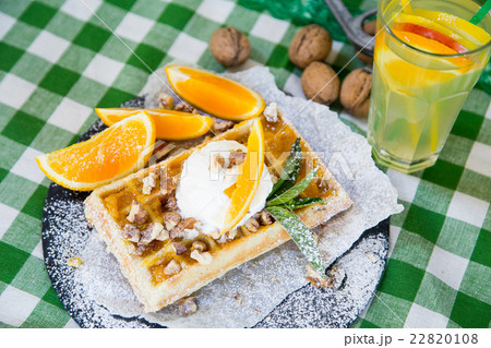 Belgian waffle with honey sauce, oranges, walnuts 22820108
