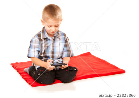 Little boy playing games on smartphone Little boy playing games on smartphone 22825866