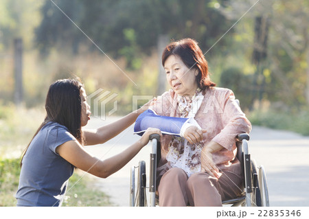 Asian woman taking their disable senior mother Asian woman taking their disable senior mother 22835346