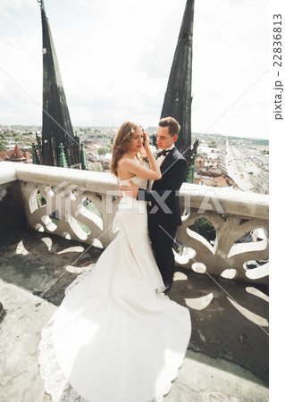 Gorgeous wedding couple walking in the old city of 22836813