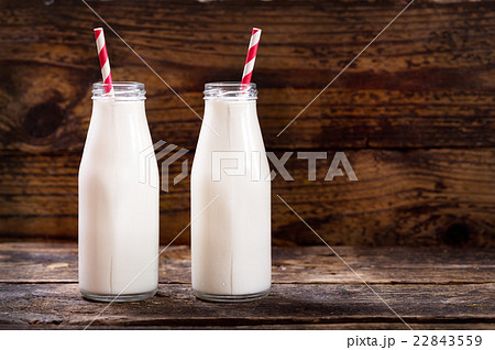 bottles of milk with straws 22843559