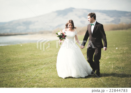 Beautiful wedding couple, bride, groom posing and Beautiful wedding couple, bride, groom posing and 22844783