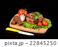 Round meat steak on a wooden board with vegetables 22845250