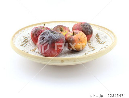 Rotten apple on plate Rotten apple on plate 22845474