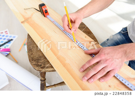 Man measuring piece of wood 22848358