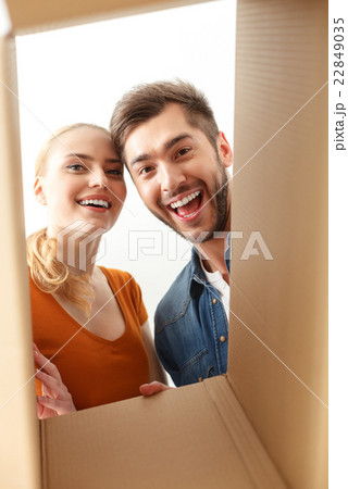 Happy couple looking inside of box Happy couple looking inside of box 22849035